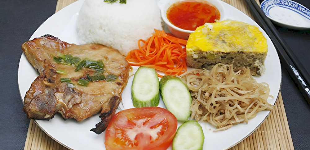 Thuy Linh Chau brings together grilled pork, egg meatloaf, pickles, and rice, all bathed in sweet chili sauce